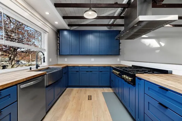a kitchen with stainless steel appliances granite countertop a refrigerator and a stove