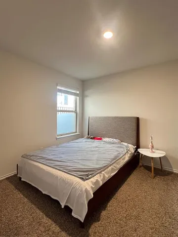 a bedroom with a bed and window