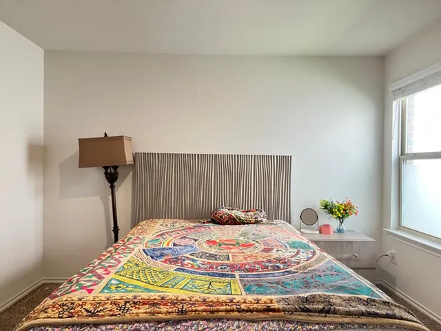 a bedroom with a bed and a window