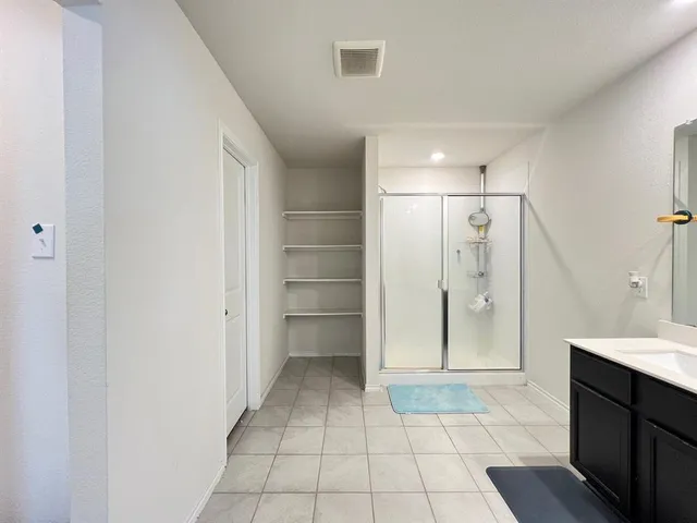 a view of a bathroom with a sink and a mirror