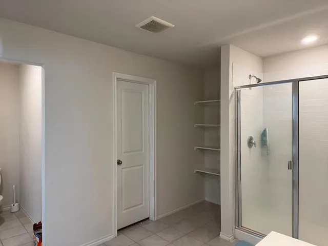 a bathroom with a glass shower door