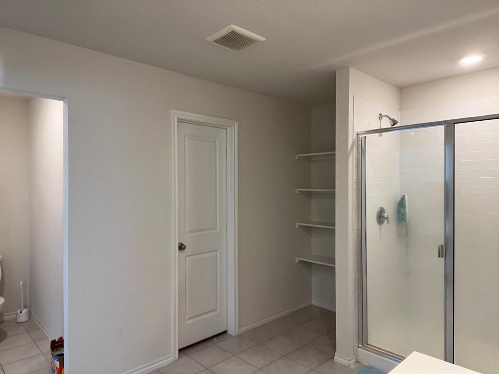 3113 Glazner Drive Forney, TX 75126 - Photo 19 of 24 a bathroom with a glass shower door