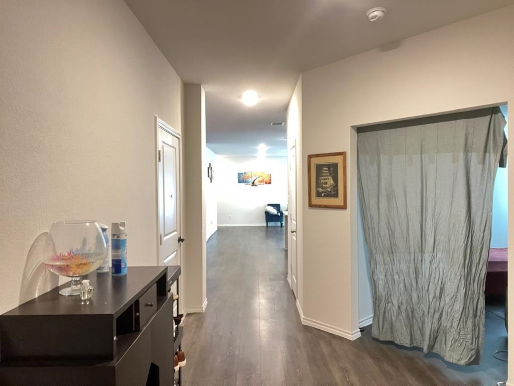 3113 Glazner Drive Forney, TX 75126 - Photo 4 of 24 a view of a hallway to a livingroom with furniture