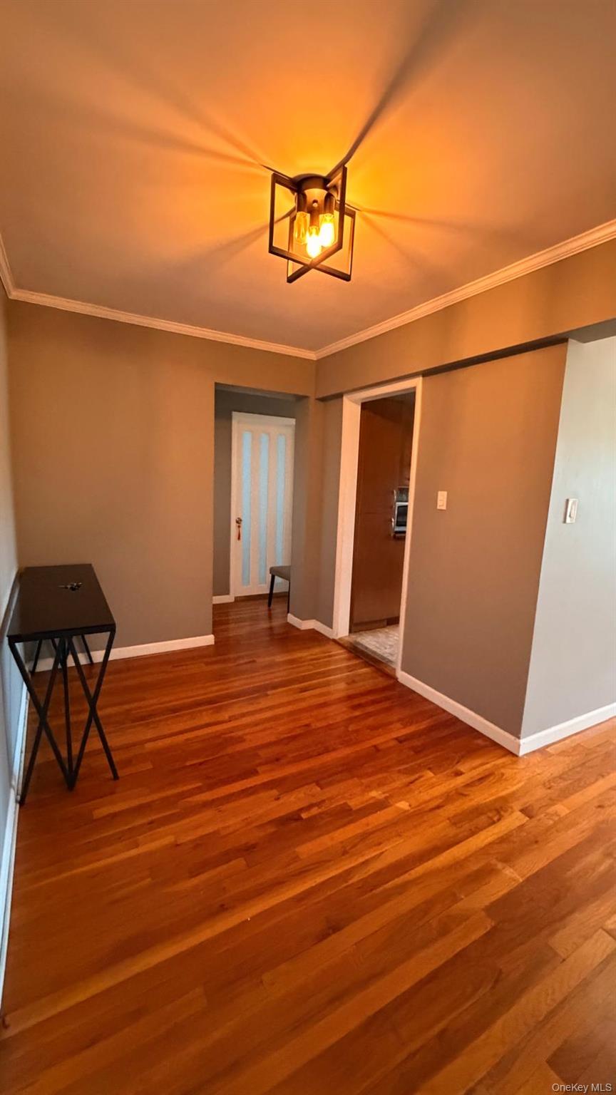 8305 98th Street, Unit 3C Queens, NY 11421 - Photo 4 of 19 a bedroom with a bed and a chandelier