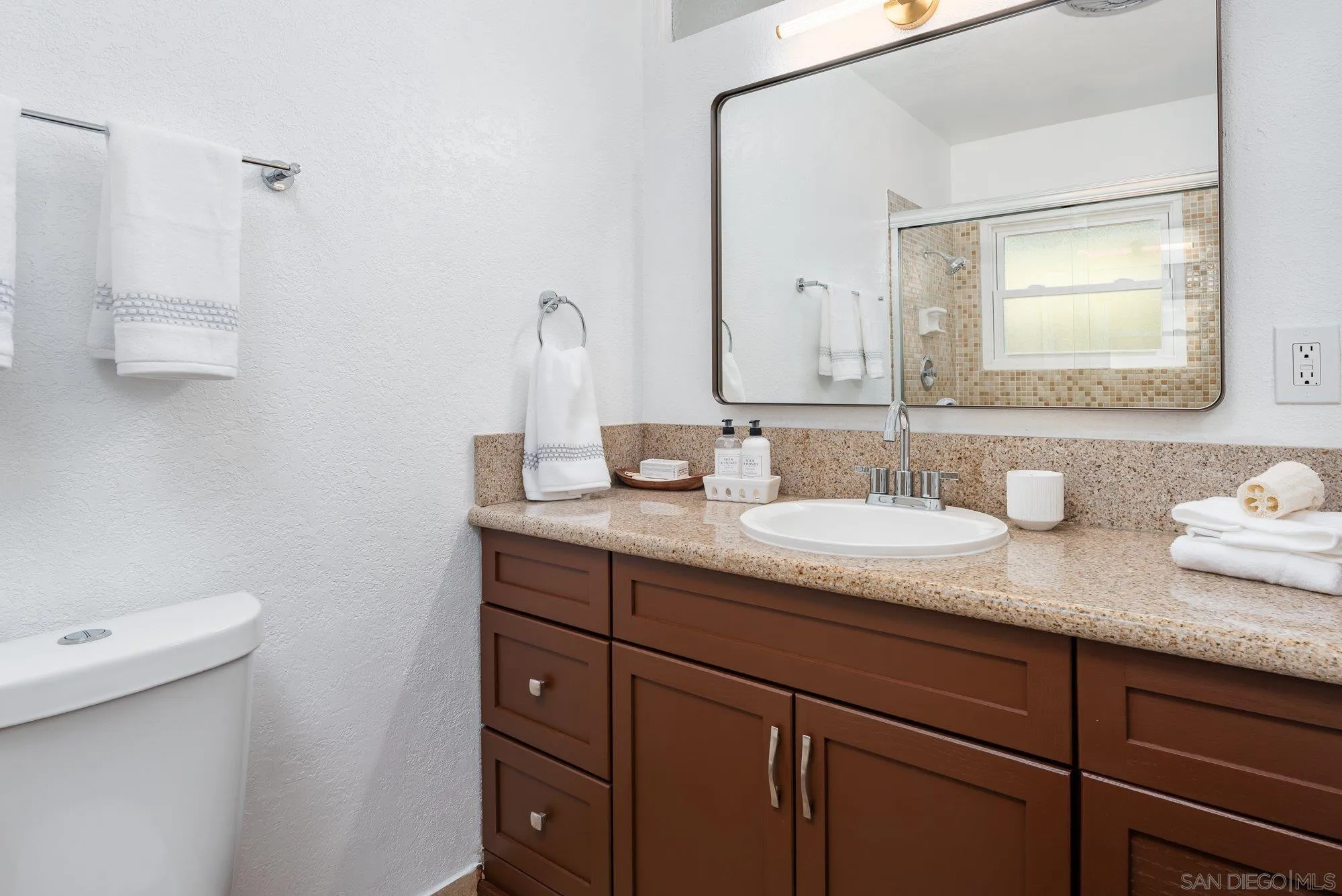 2610 Torrey Pines Road, Unit C33 La Jolla, CA 92037 - Photo 13 of 24 a bathroom with a granite countertop sink and a mirror
