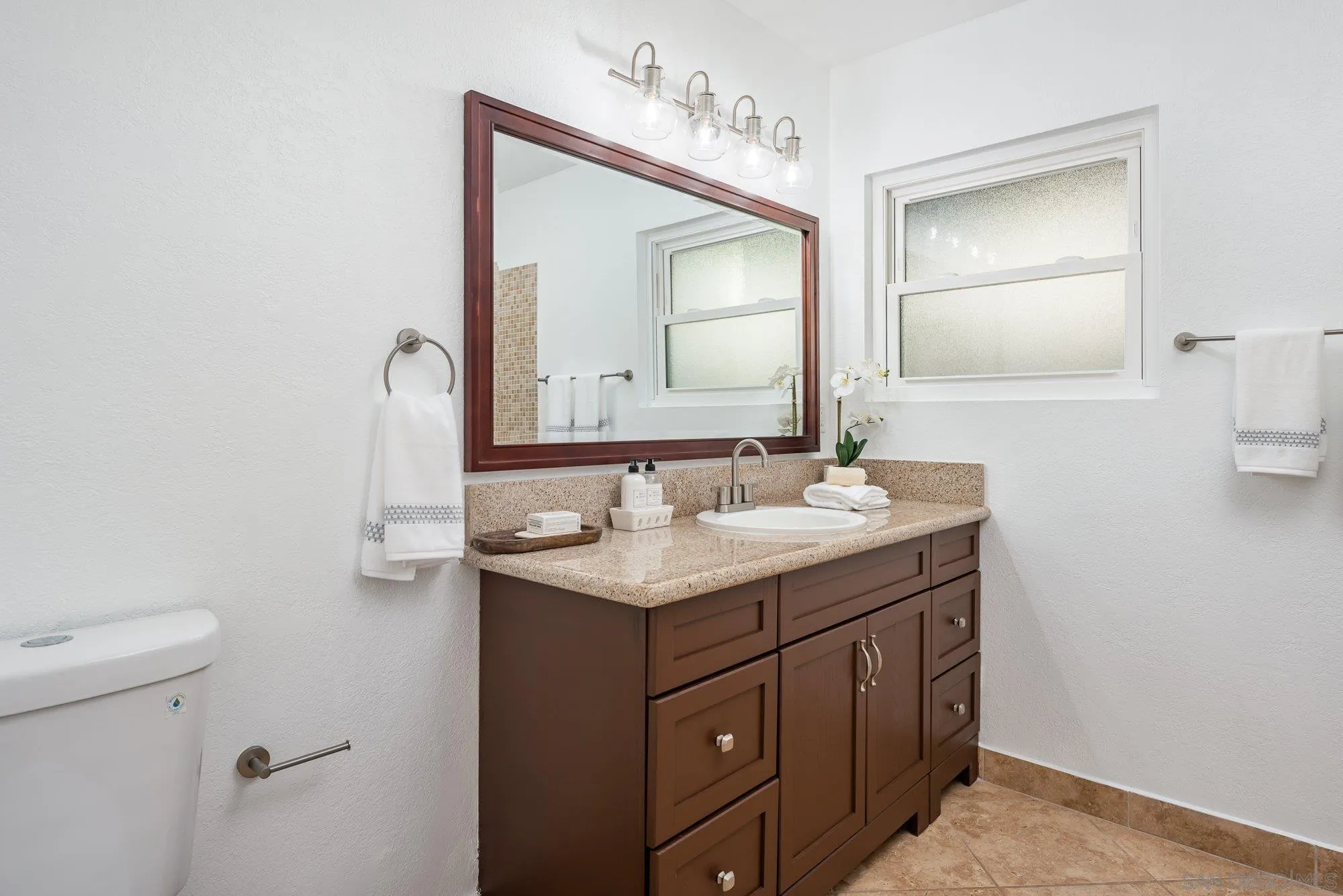2610 Torrey Pines Road, Unit C33 La Jolla, CA 92037 - Photo 15 of 24 a bathroom with a toilet sink and mirror