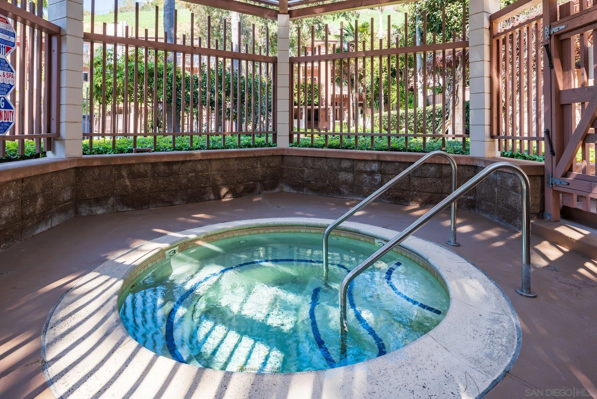 2610 Torrey Pines Road, Unit C33 La Jolla, CA 92037 - Photo 19 of 24 a view of a swimming pool with a patio and wooden fence