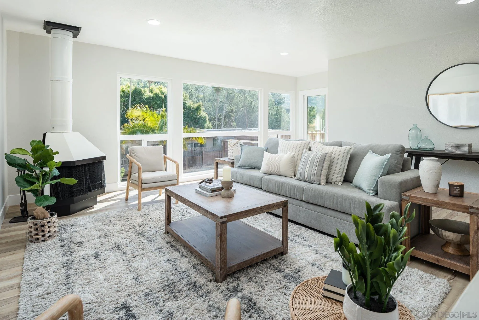 2610 Torrey Pines Road, Unit C33 La Jolla, CA 92037 - Photo 5 of 24 a living room with furniture potted plant and a large window