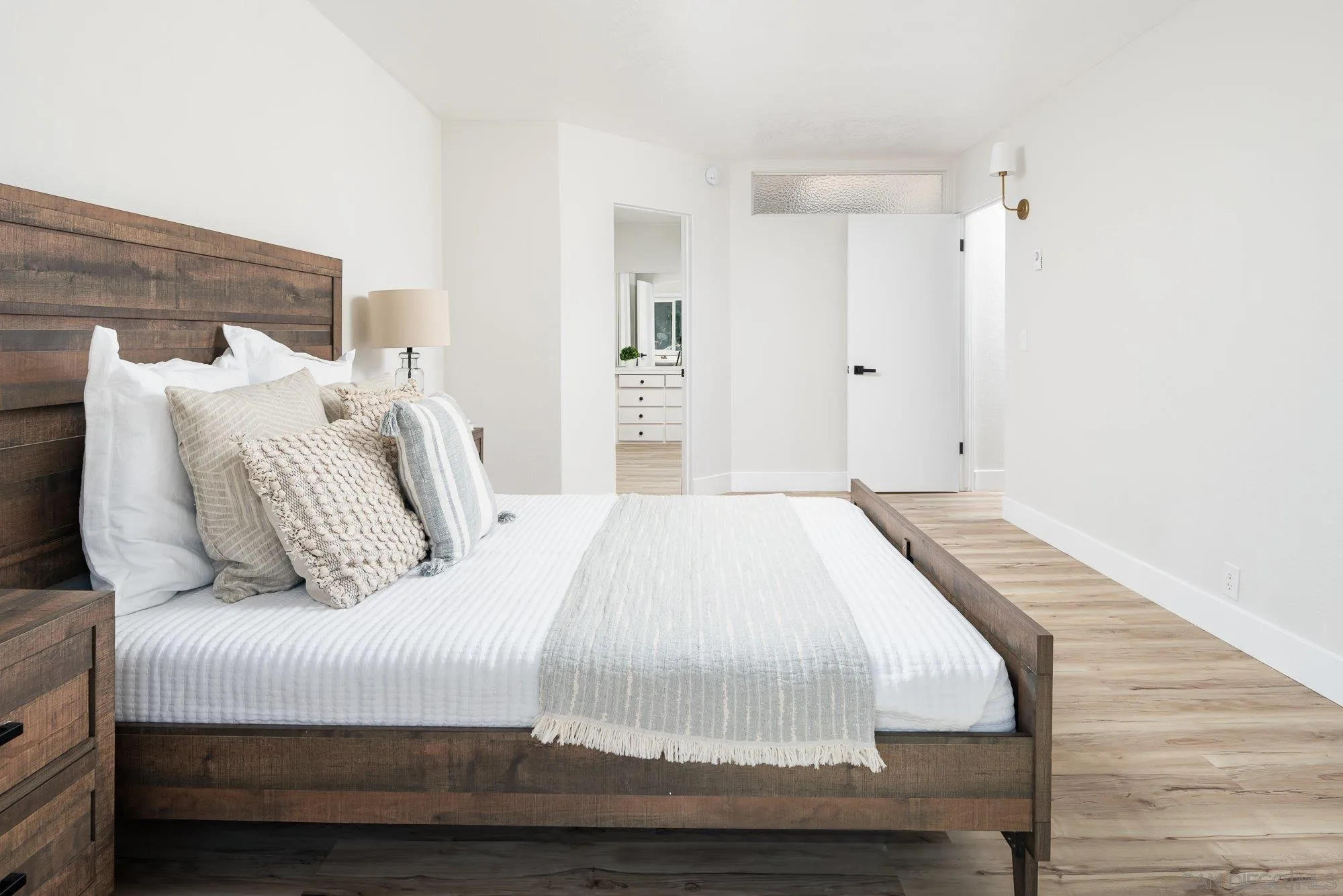 2610 Torrey Pines Road, Unit C33 La Jolla, CA 92037 - Photo 10 of 24 a bedroom with a bed and wooden floor