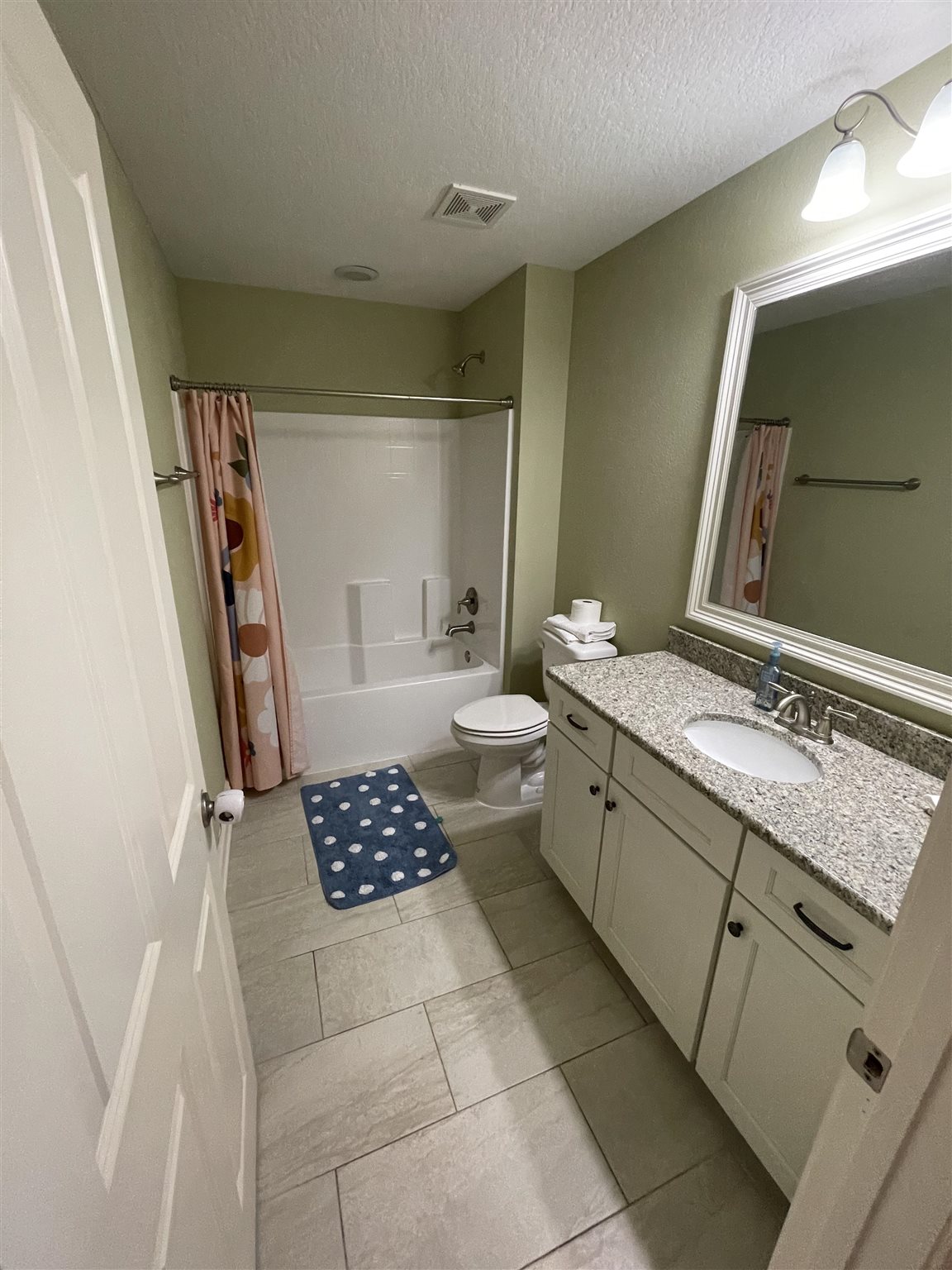 10692 Squall Line Road Pensacola, FL 32507 - Photo 20 of 29 a bathroom with a sink a toilet and a mirror