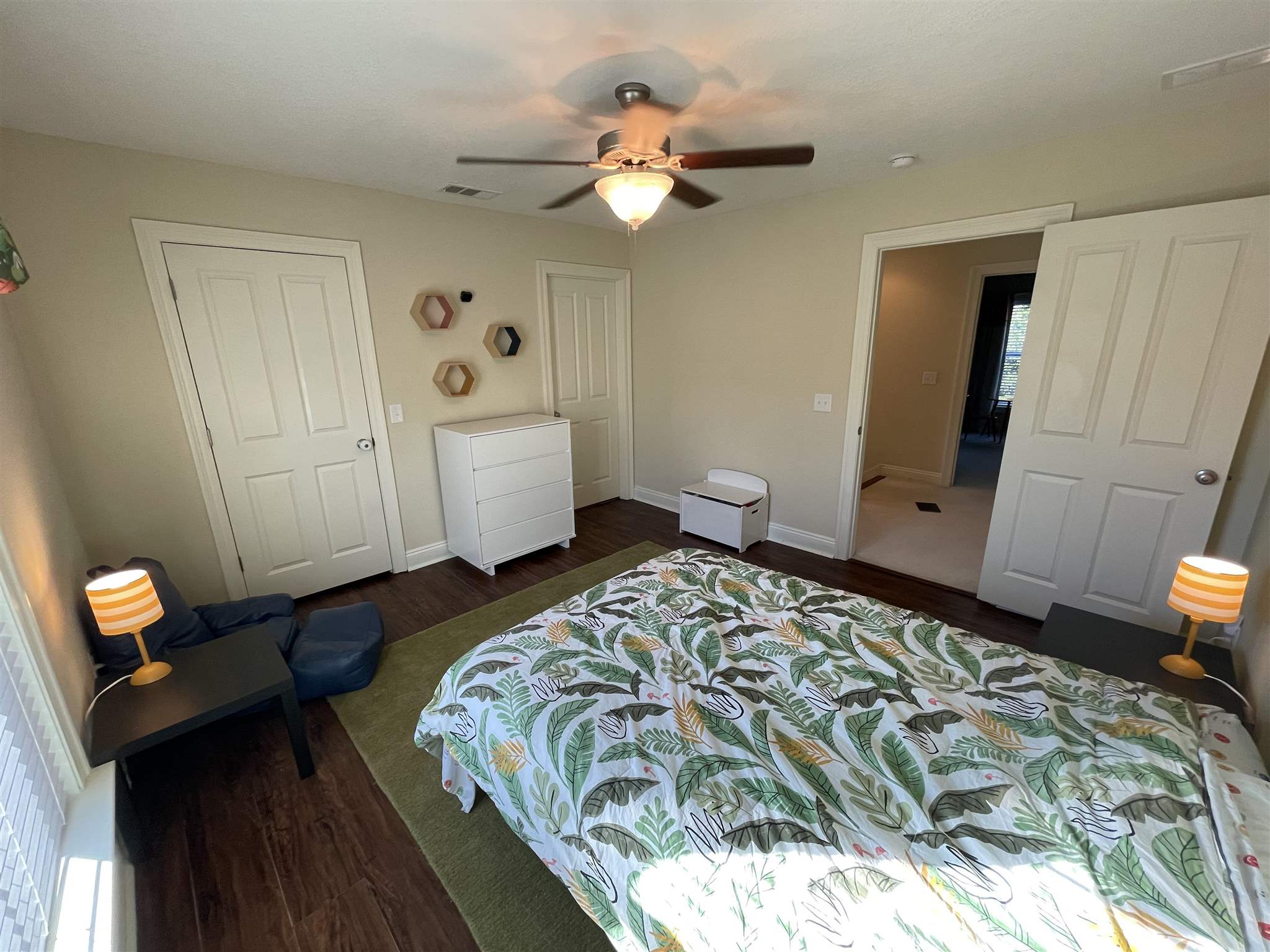 10692 Squall Line Road Pensacola, FL 32507 - Photo 22 of 29 a bedroom with a bed and a chandelier
