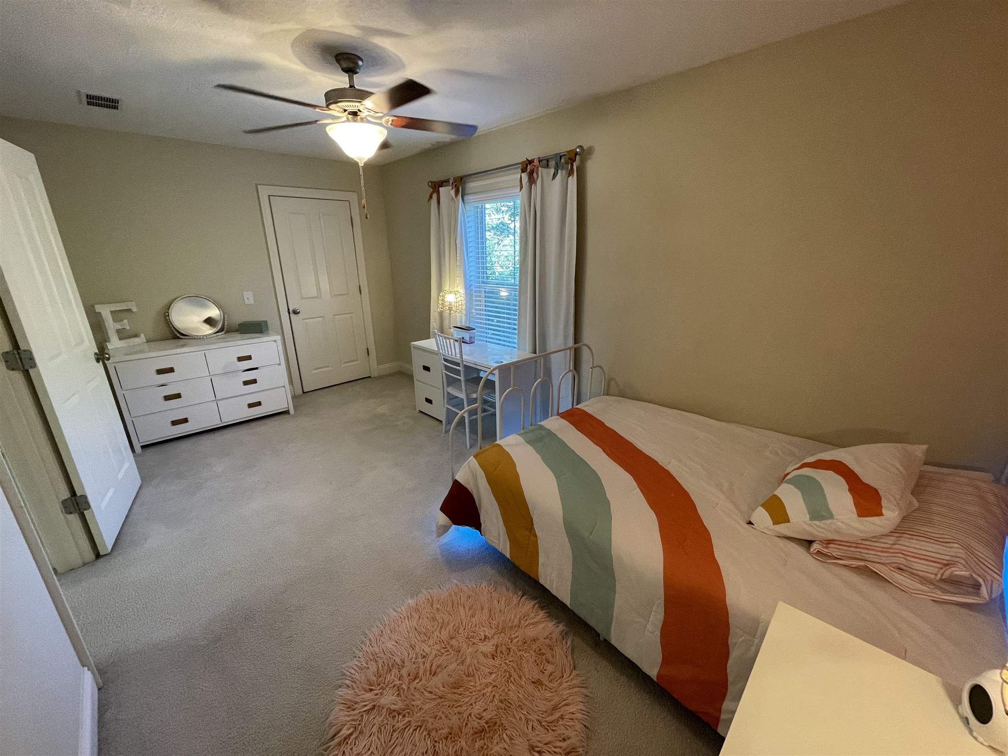 10692 Squall Line Road Pensacola, FL 32507 - Photo 23 of 29 a bedroom with a bed and a chandelier