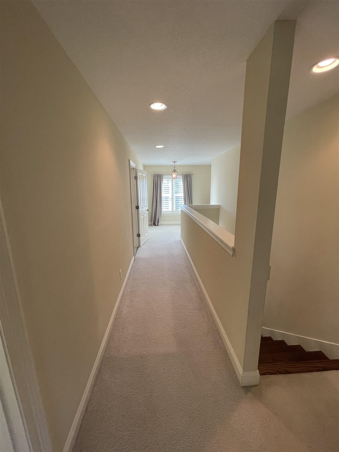 10692 Squall Line Road Pensacola, FL 32507 - Photo 25 of 29 a view of a hallway with wooden floor and a window