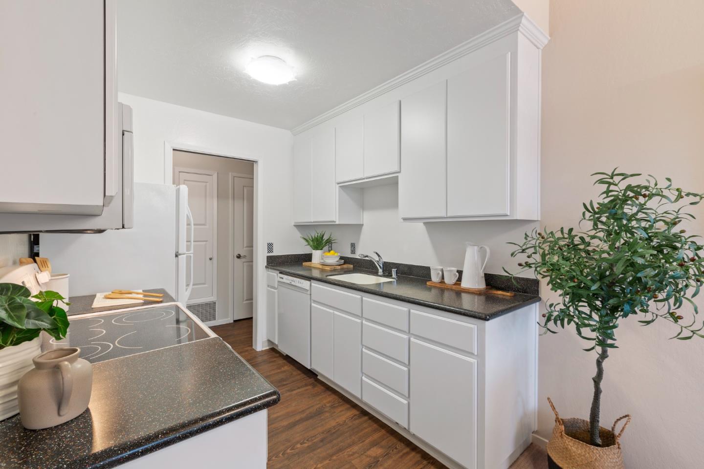 255 South Rengstorff Avenue, Unit 96 Mountain View, CA 94040 - Photo 11 of 20 a kitchen with stainless steel appliances a sink a stove and white cabinets