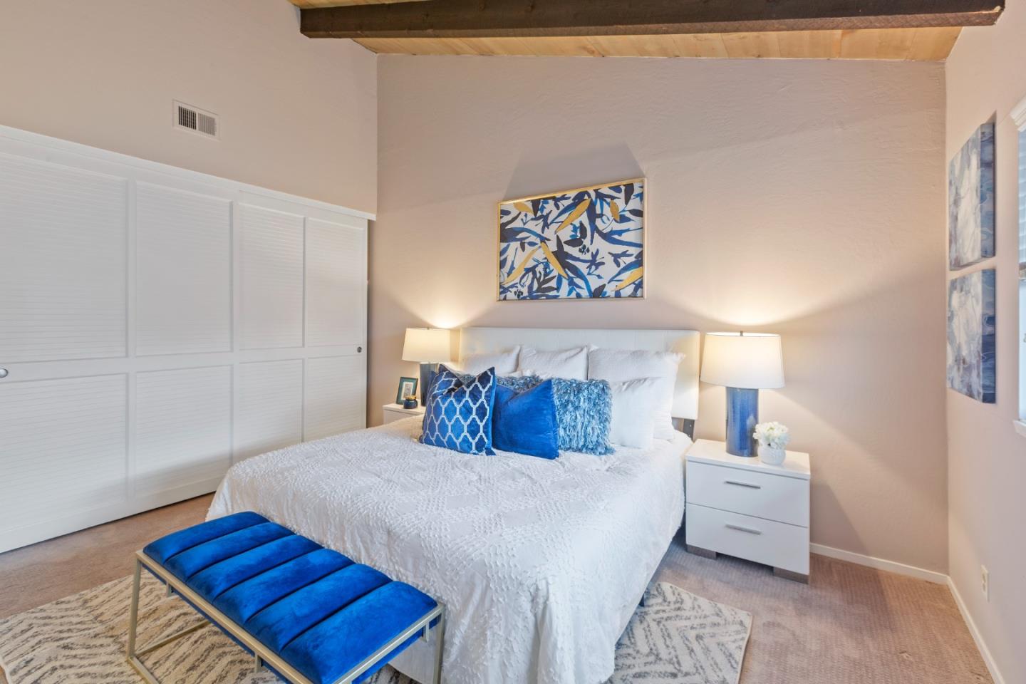 255 South Rengstorff Avenue, Unit 96 Mountain View, CA 94040 - Photo 14 of 20 a bedroom with a bed and a night stand