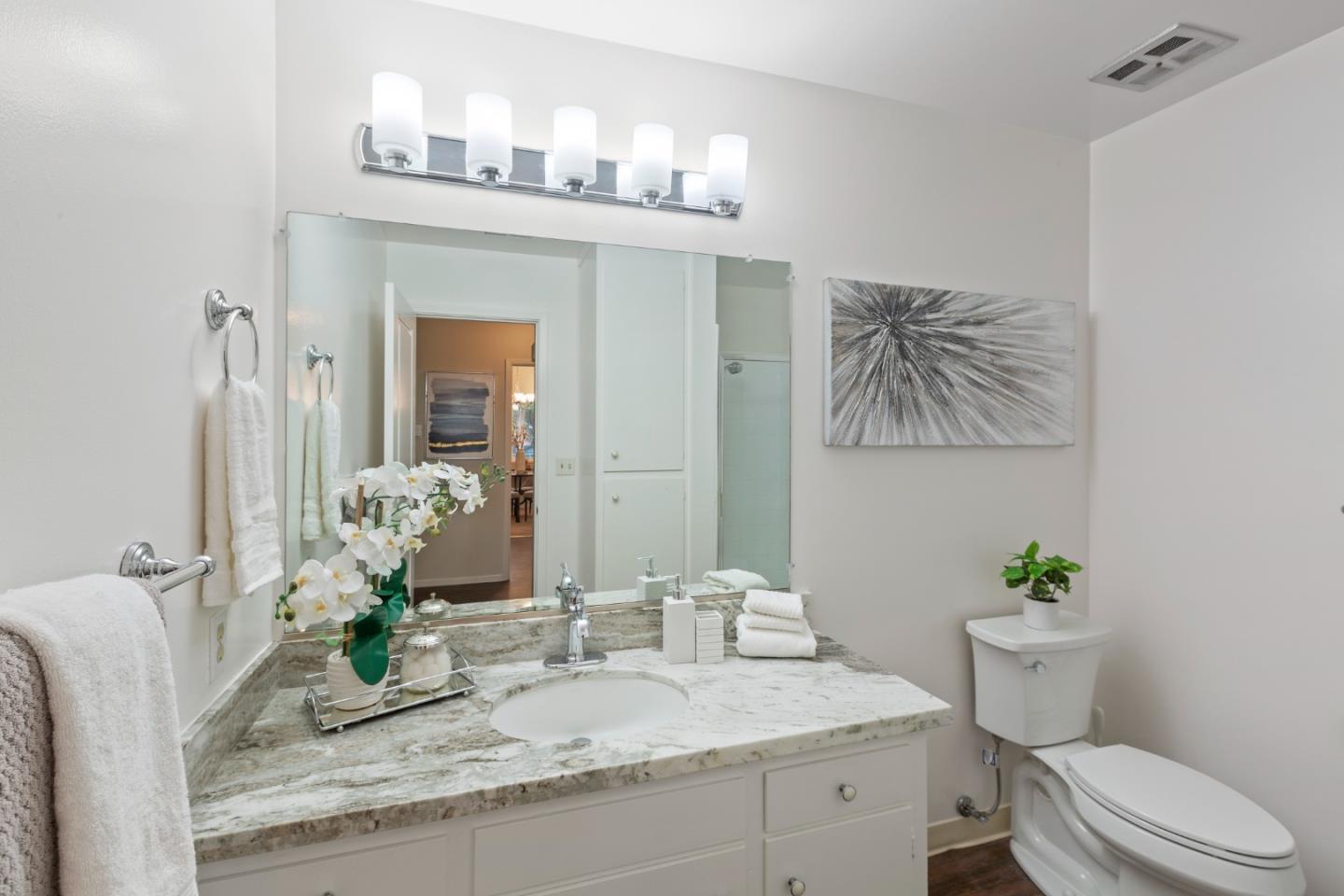 255 South Rengstorff Avenue, Unit 96 Mountain View, CA 94040 - Photo 15 of 20 a bathroom with a granite countertop sink a toilet and a large mirror