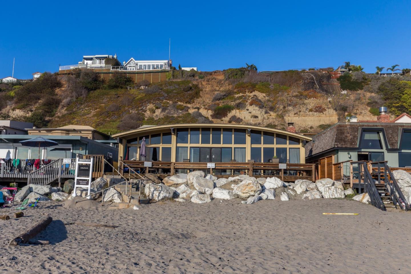 638 Beach Drive Aptos, CA 95003 - Photo 2 of 40 a front view of a house with a yard and garage