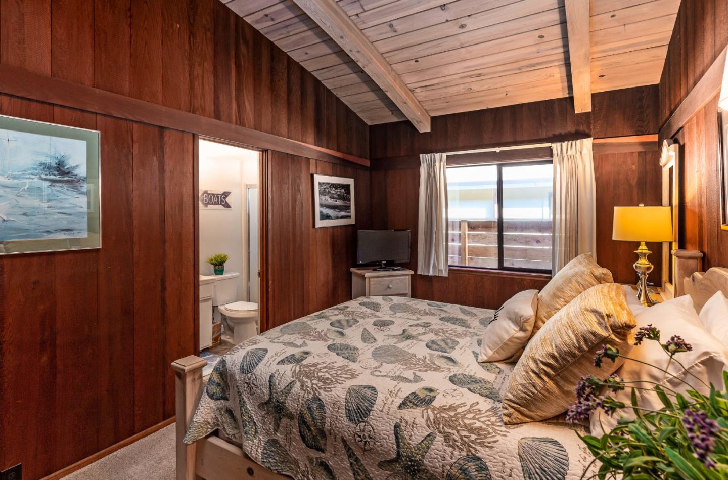 638 Beach Drive Aptos, CA 95003 - Photo 30 of 40 a bedroom with a bed and wooden floor