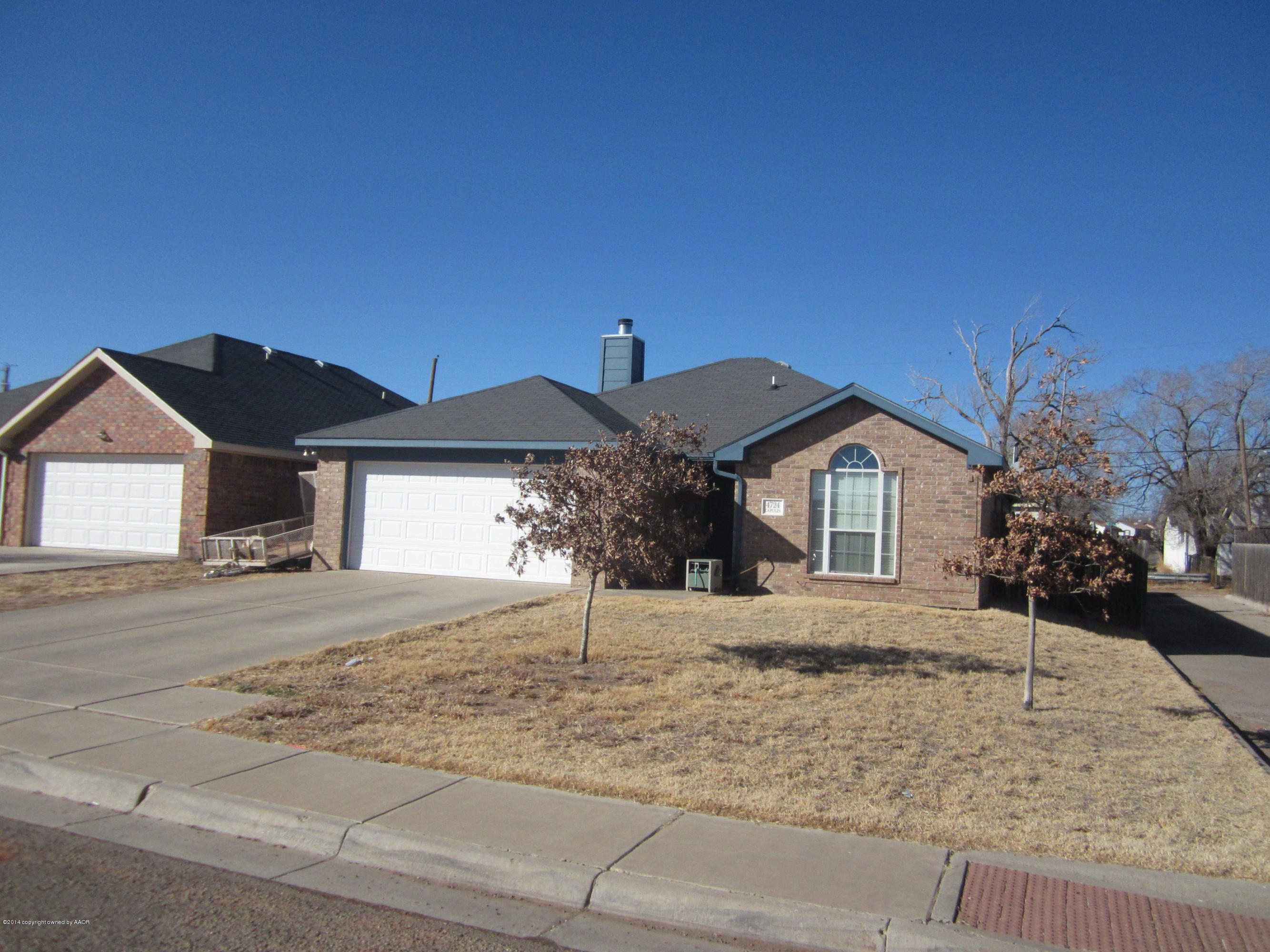 4724 Capulin Lane Amarillo, TX 79110 - Photo 1 of 23 a front view of a house with a yard and garage