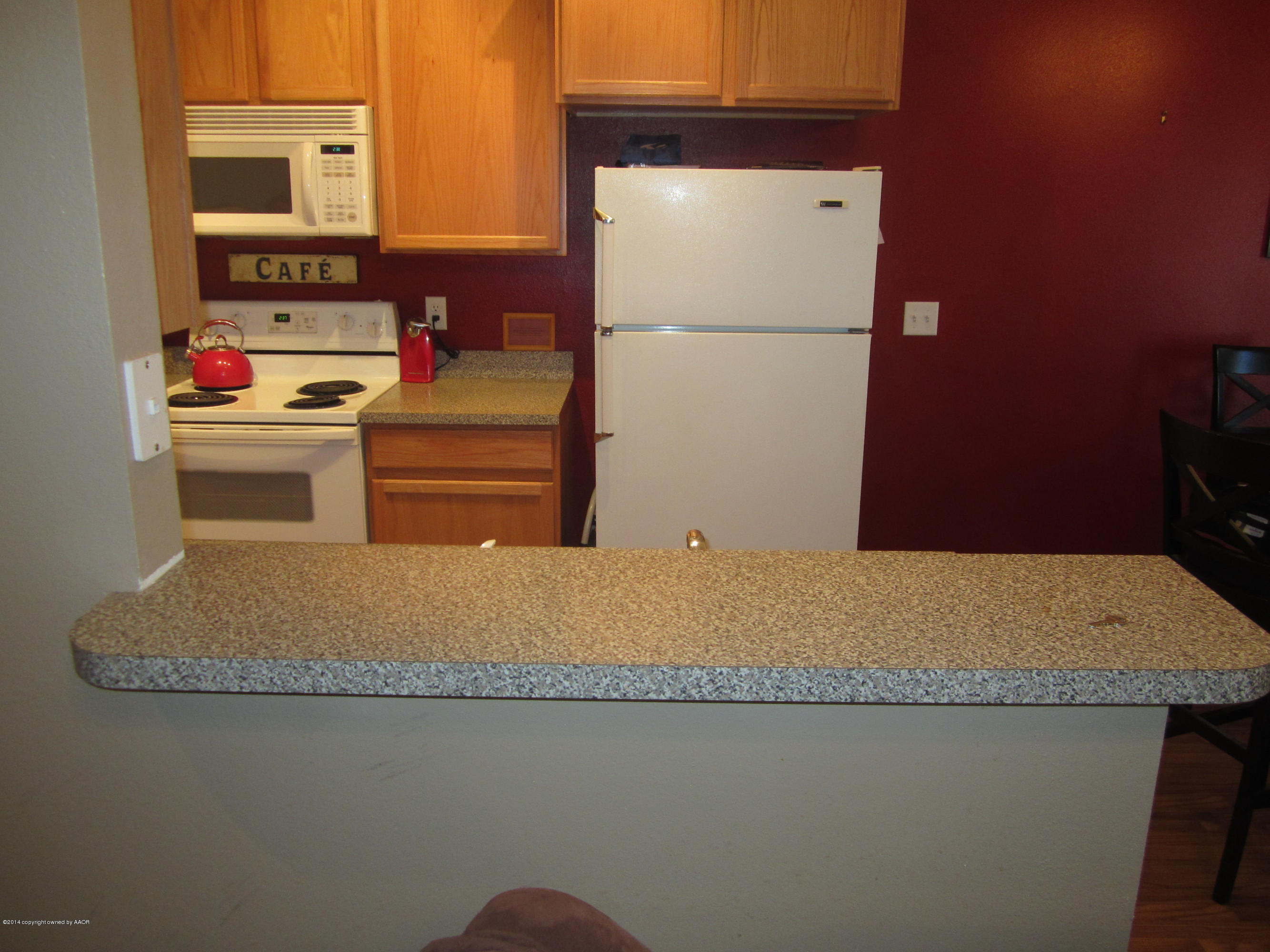 4724 Capulin Lane Amarillo, TX 79110 - Photo 11 of 23 a kitchen with a refrigerator and stove