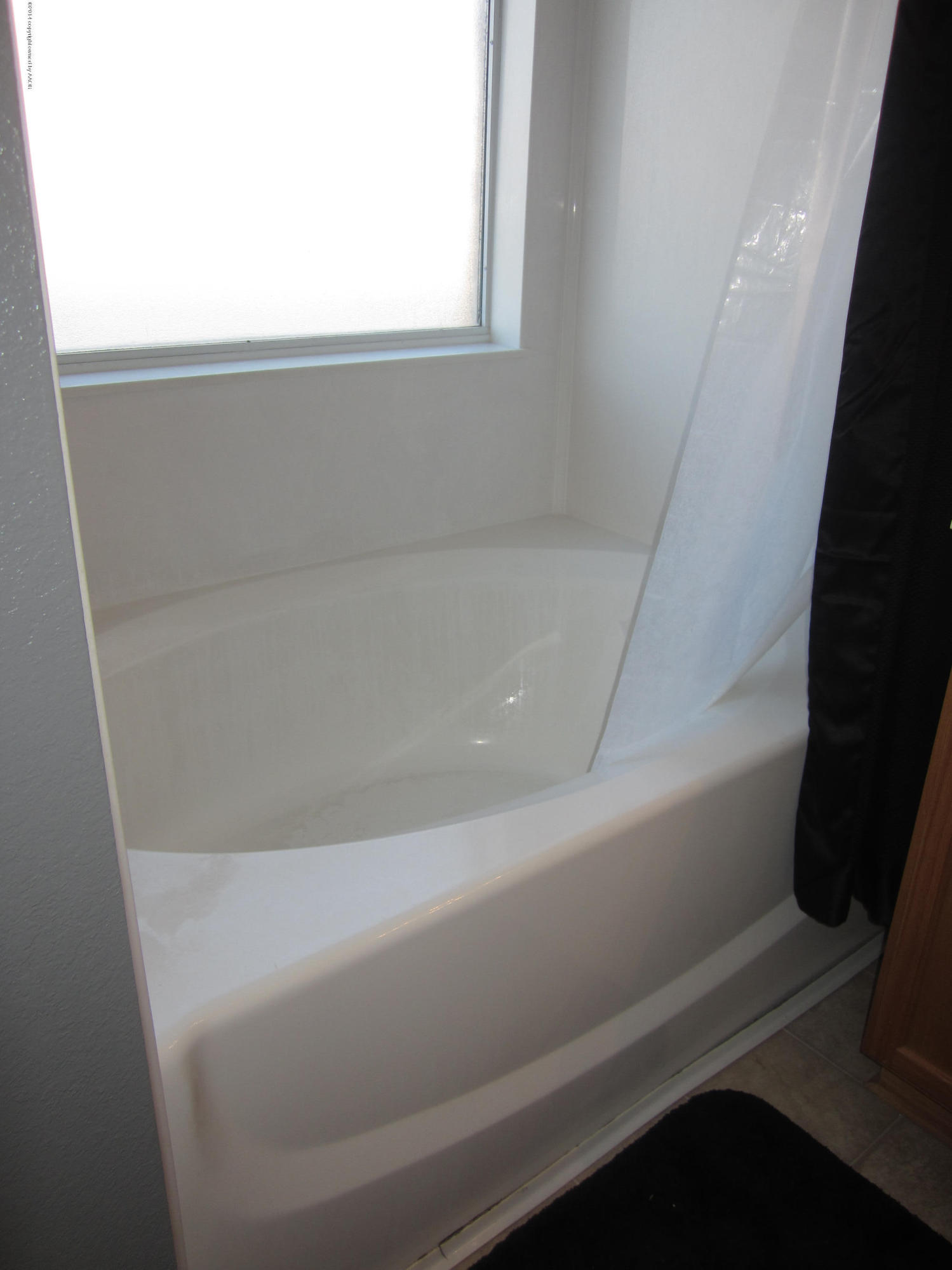 4724 Capulin Lane Amarillo, TX 79110 - Photo 13 of 23 a close up of a bathtub