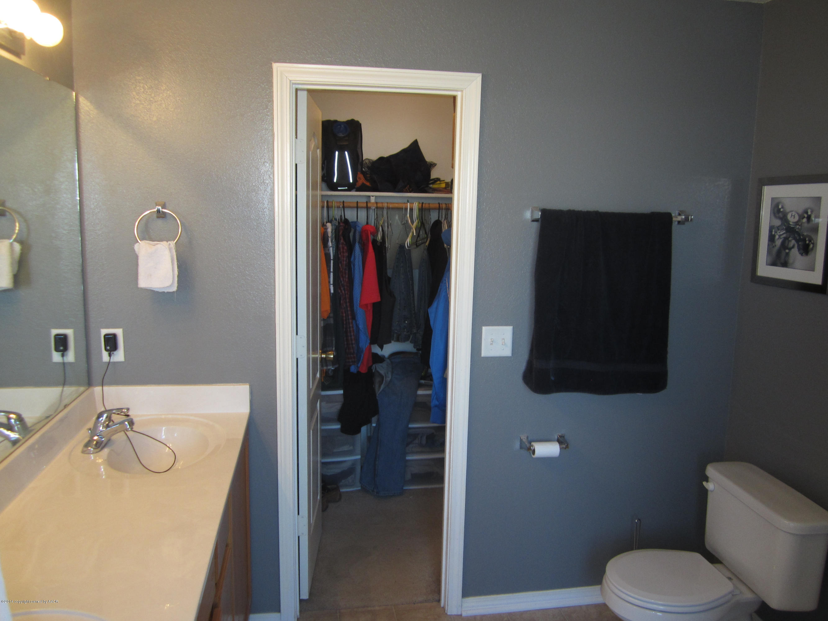 4724 Capulin Lane Amarillo, TX 79110 - Photo 14 of 23 a bathroom with a sink and mirror