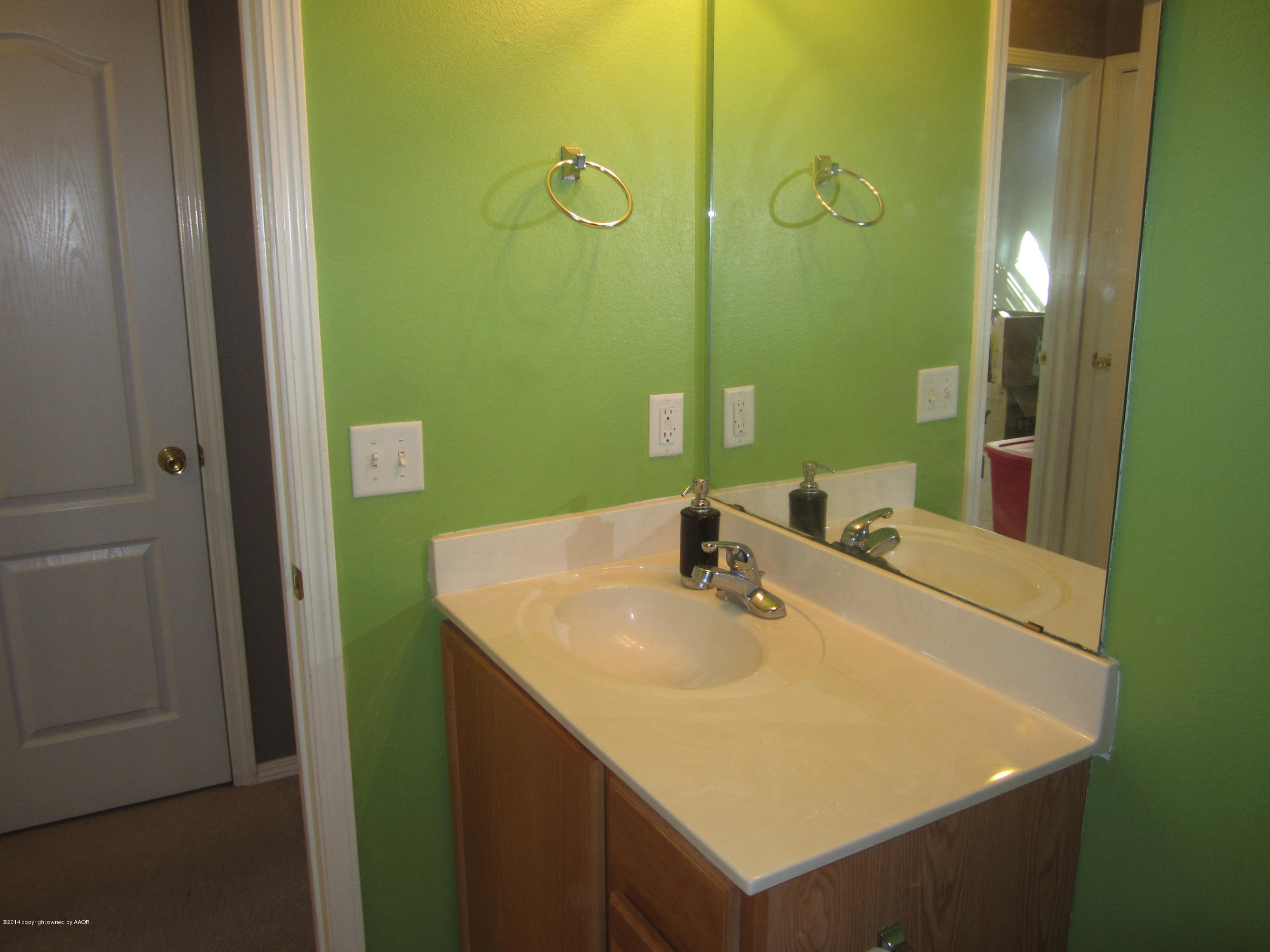 4724 Capulin Lane Amarillo, TX 79110 - Photo 17 of 23 a bathroom with a sink and a mirror