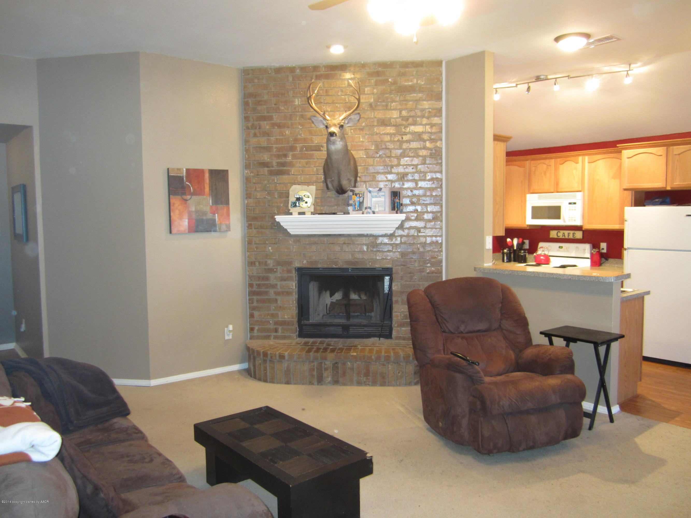 4724 Capulin Lane Amarillo, TX 79110 - Photo 4 of 23 a living room with furniture and a fireplace