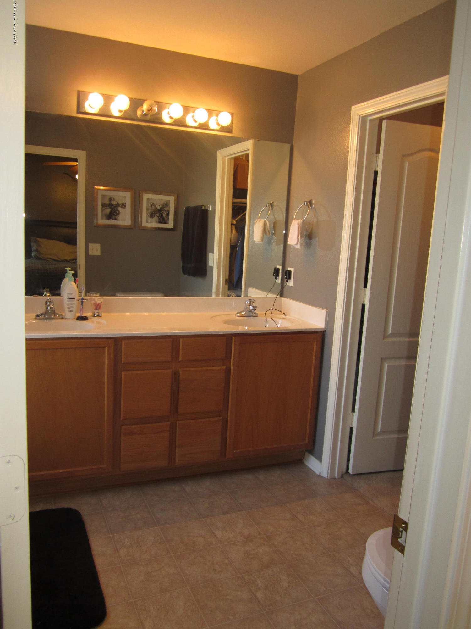 4724 Capulin Lane Amarillo, TX 79110 - Photo 6 of 23 a bathroom with a double vanity sink and a mirror