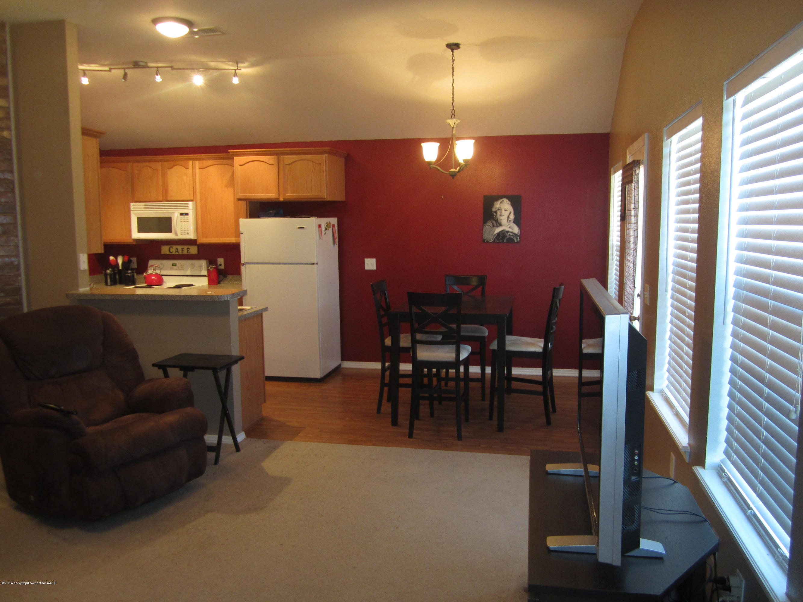 4724 Capulin Lane Amarillo, TX 79110 - Photo 8 of 23 a view of a dining room with furniture window and wooden floor