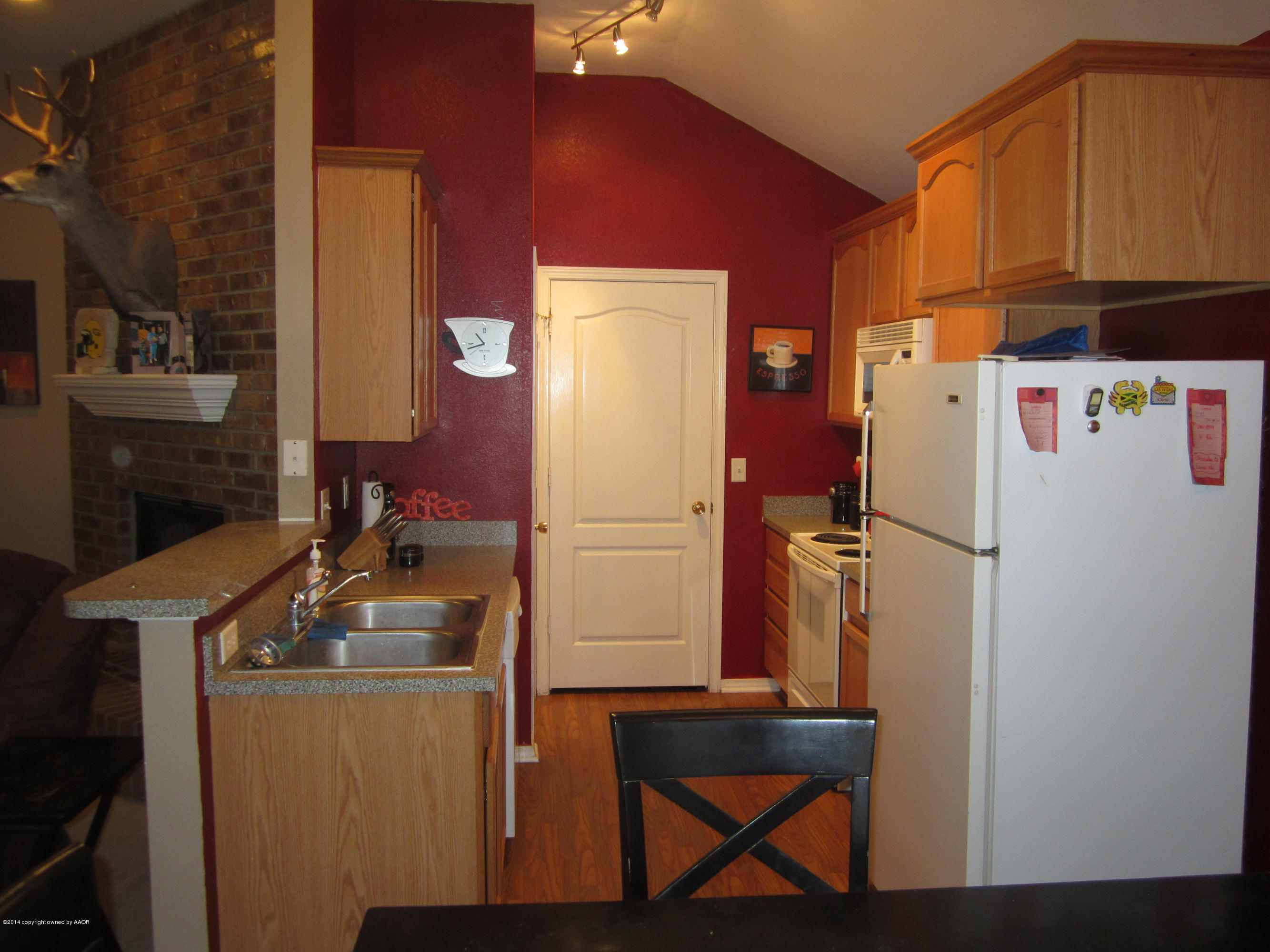 4724 Capulin Lane Amarillo, TX 79110 - Photo 9 of 23 a room with refrigerator and cabinets
