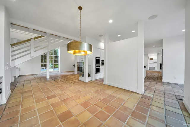 a view of a kitchen with a sink and a chandelier