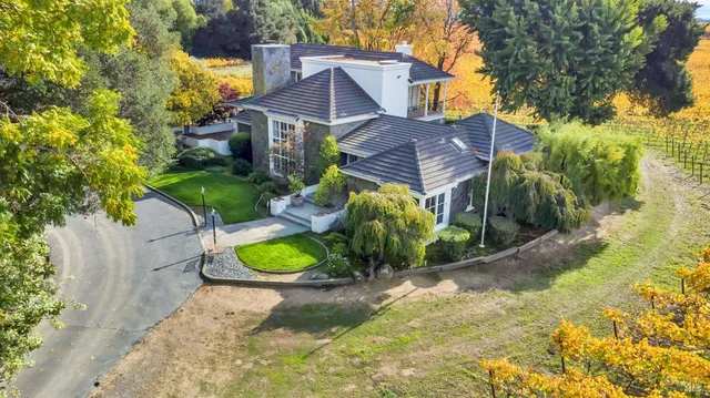a view of a house with a yard and a sitting area