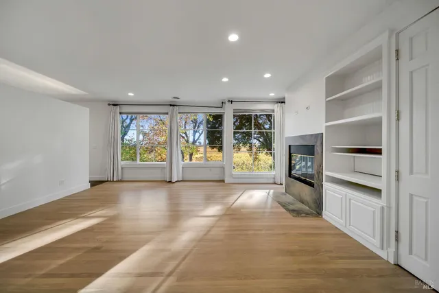 a view of an entryway with wooden floor and windows