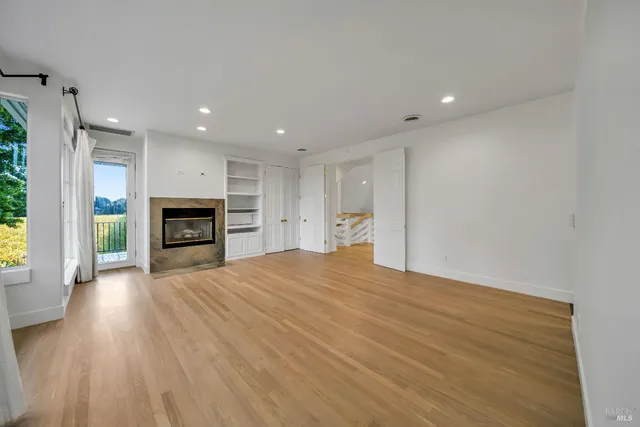 a view of an empty room with a fireplace