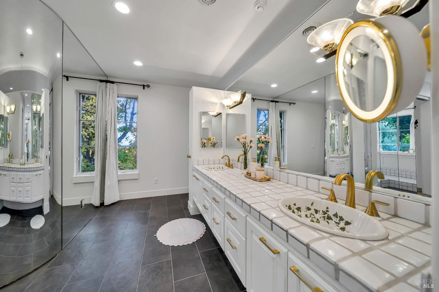 1041 Las Amigas Road Napa, CA 94559 - Photo 27 of 46 a bathroom with a granite countertop sink a mirror and a shower