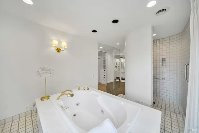 a bathroom with a tub and a shower