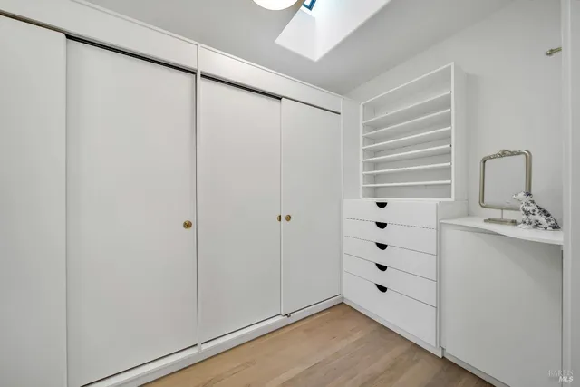 a view of an empty room with cabinet and entryway