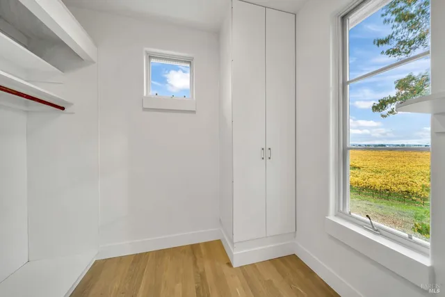a view of room with window and wooden floor