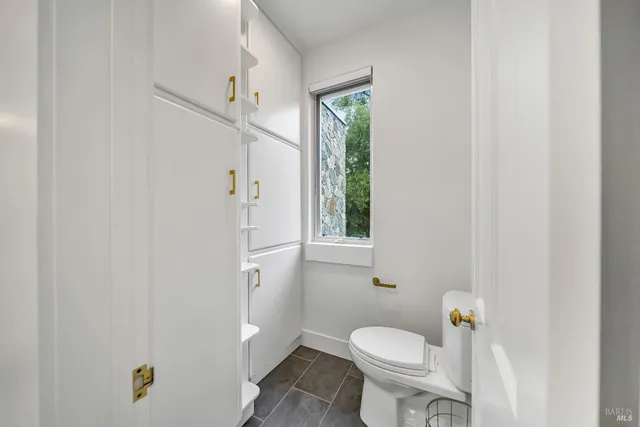 a white toilet sitting next to a bathroom sink