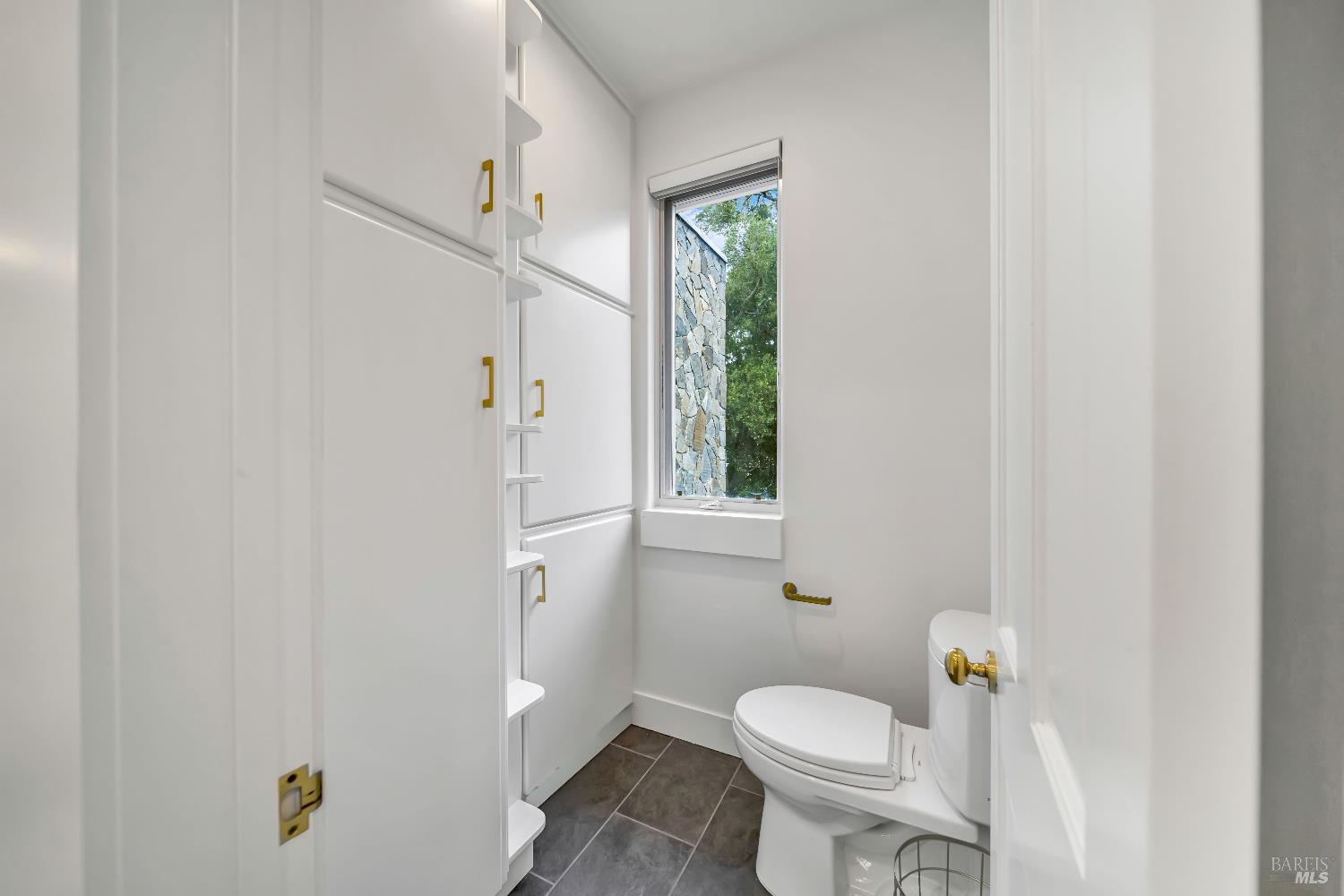 1041 Las Amigas Road Napa, CA 94559 - Photo 33 of 46 a white toilet sitting next to a bathroom sink