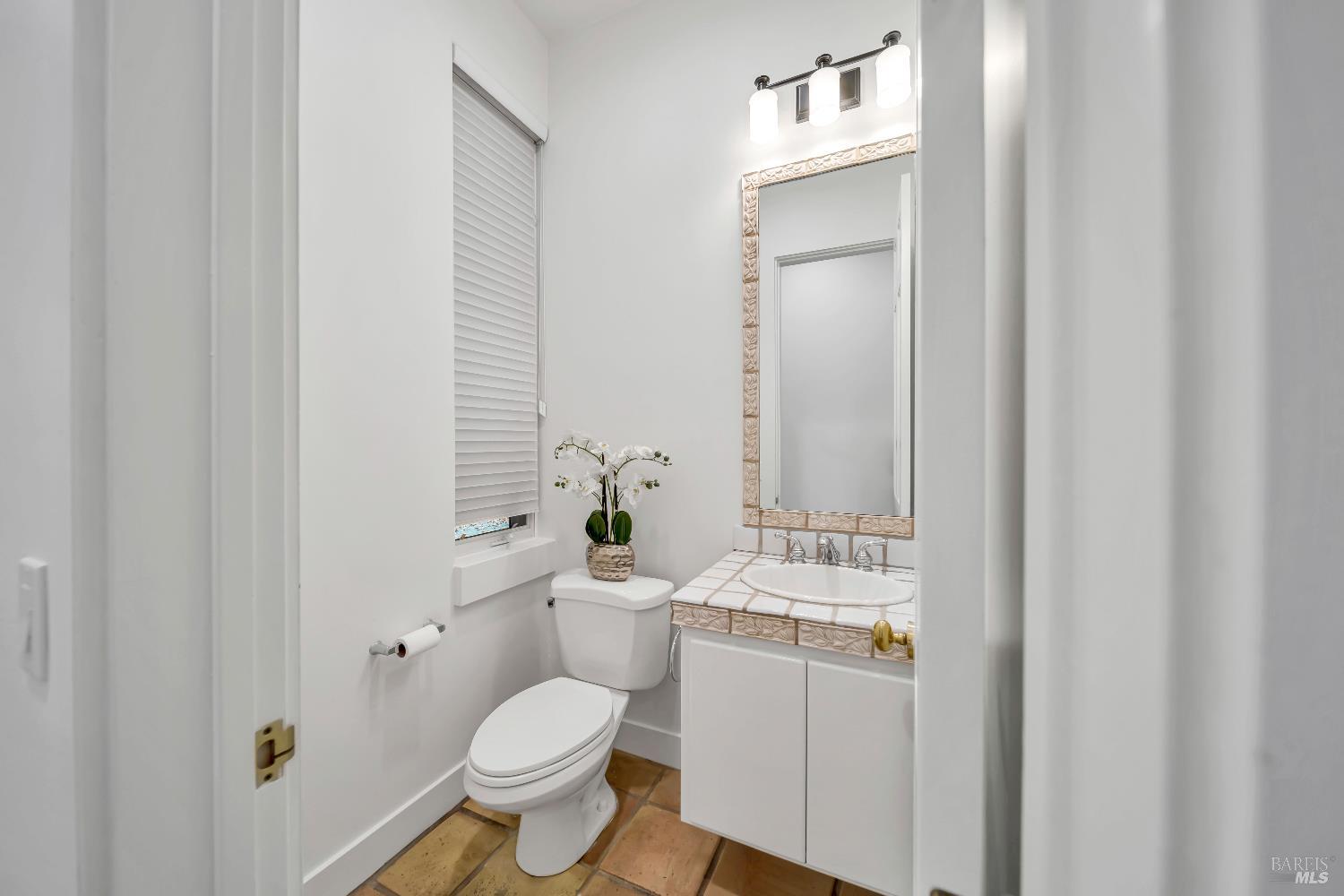1041 Las Amigas Road Napa, CA 94559 - Photo 35 of 46 a bathroom with a toilet sink vanity and mirror