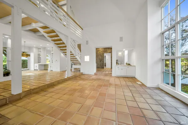 a view of an entryway with wooden floor and a living room