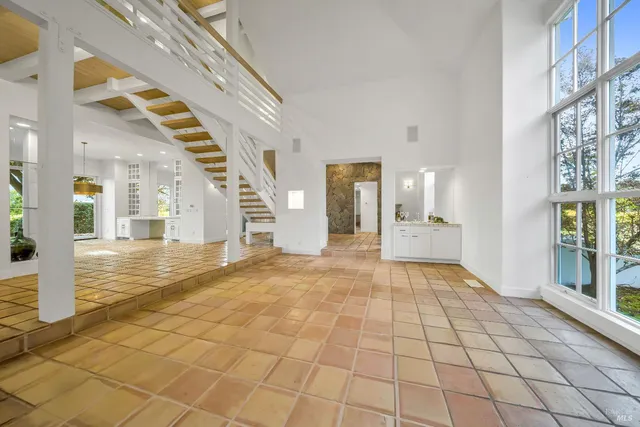 a view of an entryway with wooden floor and a living room