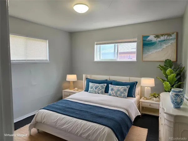 a bedroom with a bed and a potted plant