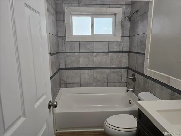 a bathroom with a toilet and shower
