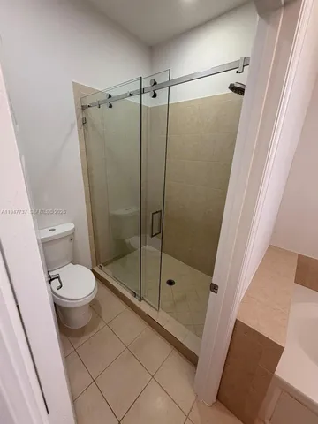 a bathroom with a toilet and a shower
