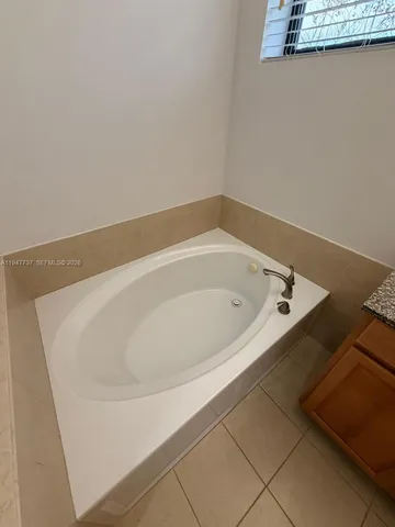 a white bath tub sitting in a bathroom