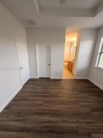 a view of an empty room and wooden floor