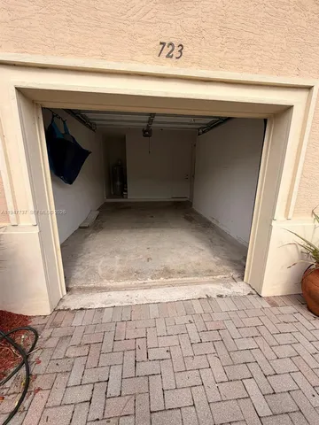 a view of a livingroom with wooden floor and white cabinet